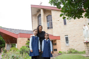 Mother and two daughters in front of St Michael's parish