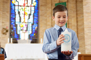 Student inside of church holding the St MIchael's Catholic Primary School Daceyville candle