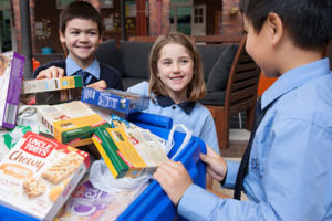 Students at St Michae;'s Catholic Primary School Daceyville packing hamper for donation to local charity